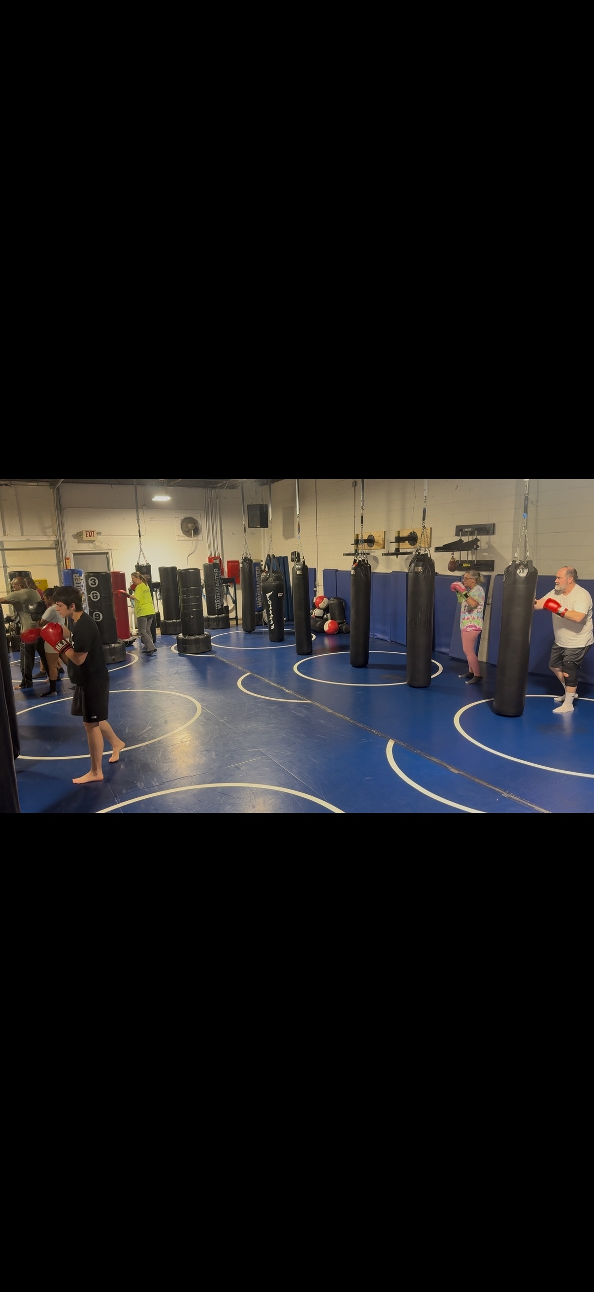 Kickboxing class with heavy bags at American Karate Center